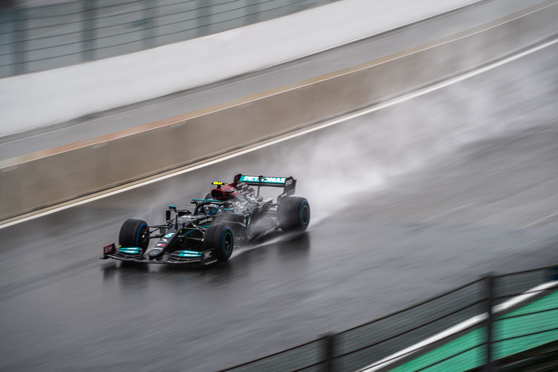 Lewis Hamilton in a Mercedes Formula 1 car in the rain