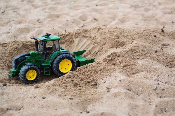 Toy tractor in a sandbox